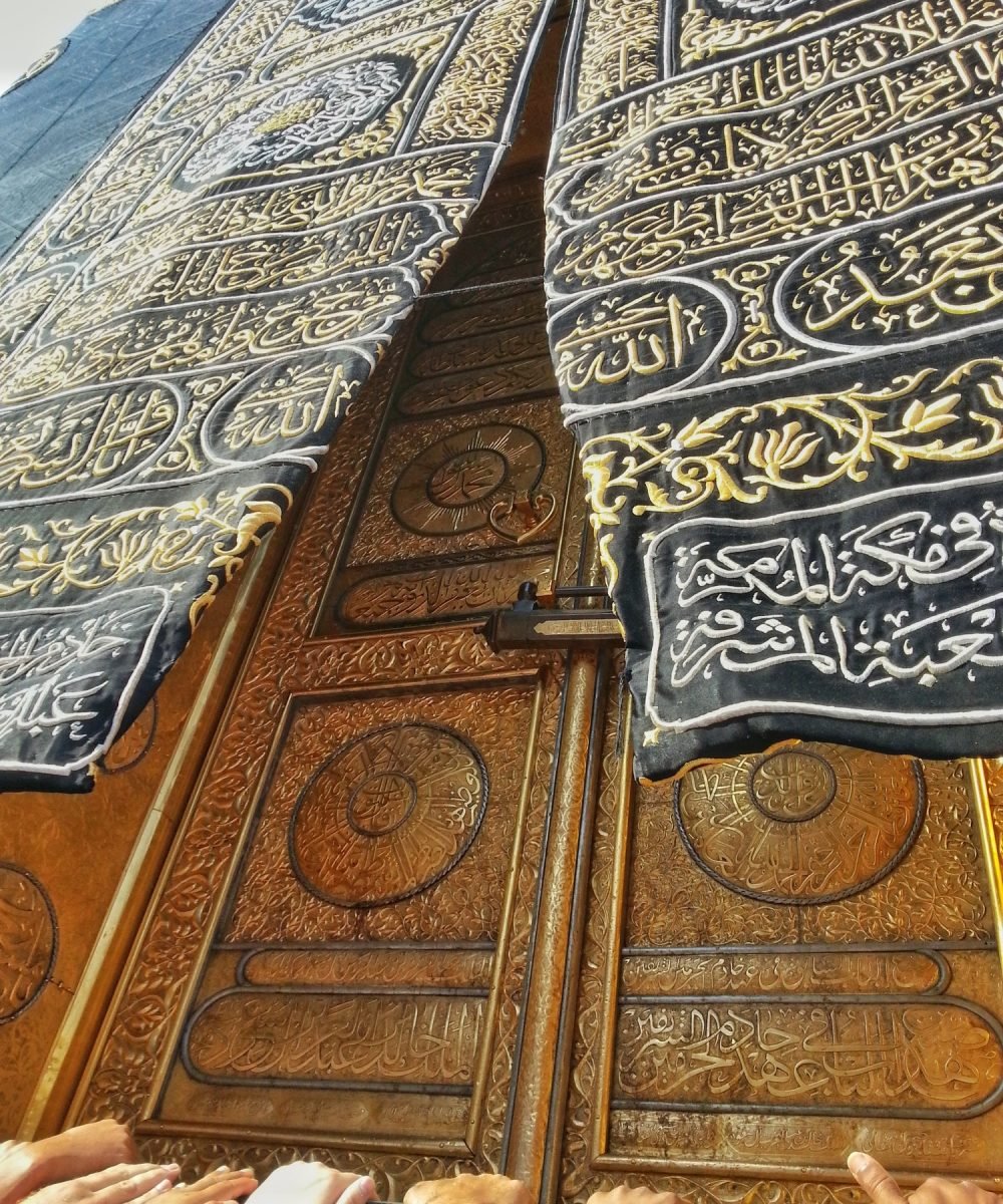 Hand of muslim approaching and touching the Kaabah in Mecca